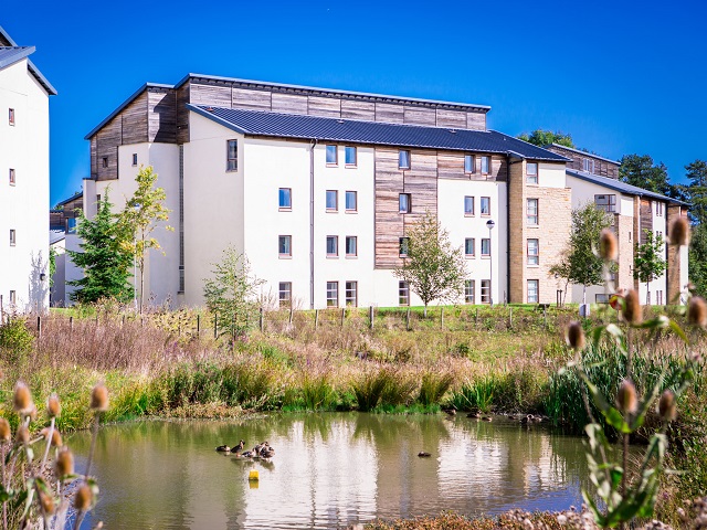 exterior of David Russell Apartment next to pond