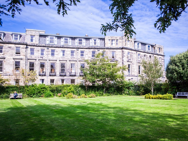 exterior of McIntosh Hall in front of gardens